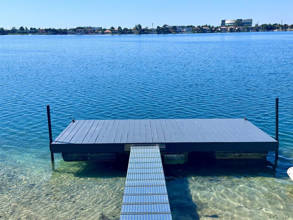 14024 Southwest 132nd Avenue Miami, FL 33186 - Photo 24 of 24 a balcony with wooden floor and lake view