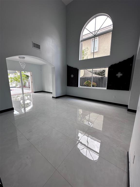 14024 Southwest 132nd Avenue Miami, FL 33186 - Photo 9 of 24 an empty room with windows fireplace and sink