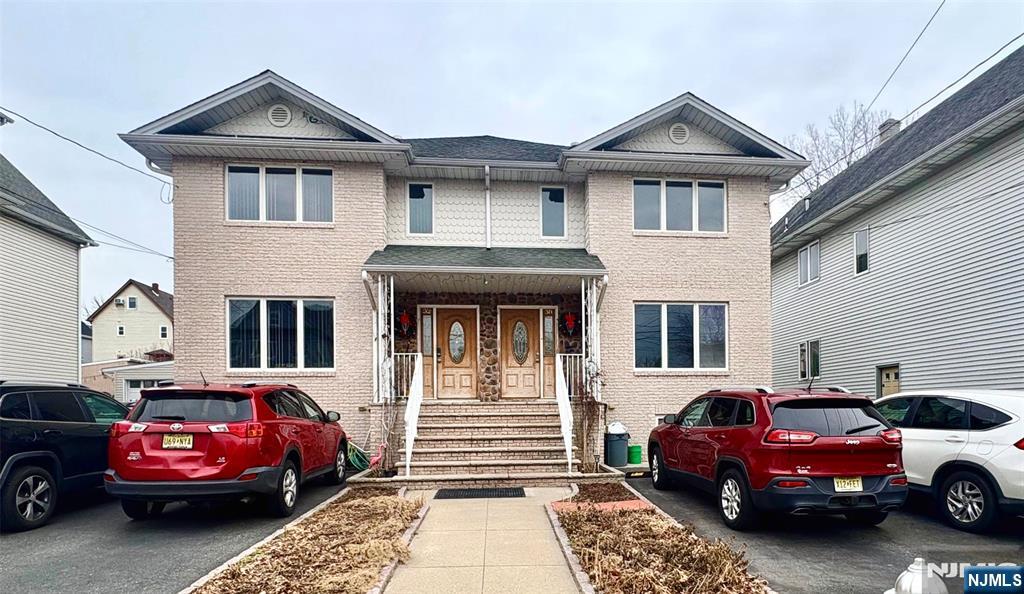 32 Orchard Street Garfield, NJ 07026 - Photo 1 of 14 a front view of a house with parking space