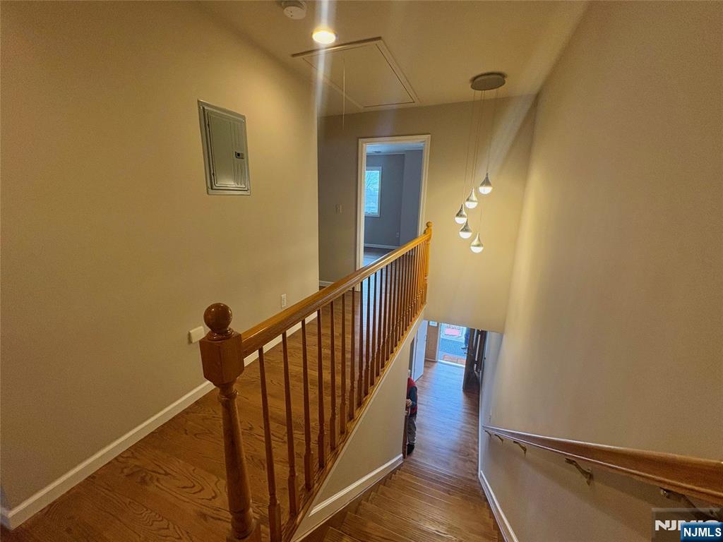 32 Orchard Street Garfield, NJ 07026 - Photo 6 of 14 a view of a hallway with wooden floor and staircase
