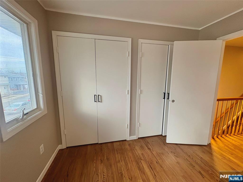 32 Orchard Street Garfield, NJ 07026 - Photo 9 of 14 a view of an empty room with wooden floor and a window