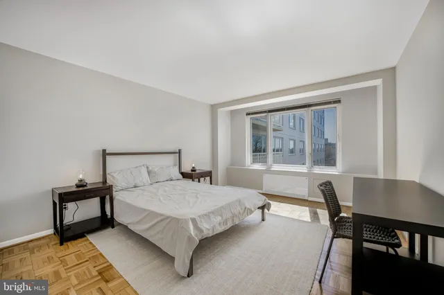 a bedroom with a bed and a table in it