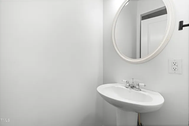 an empty room with wooden floor fireplace and windows