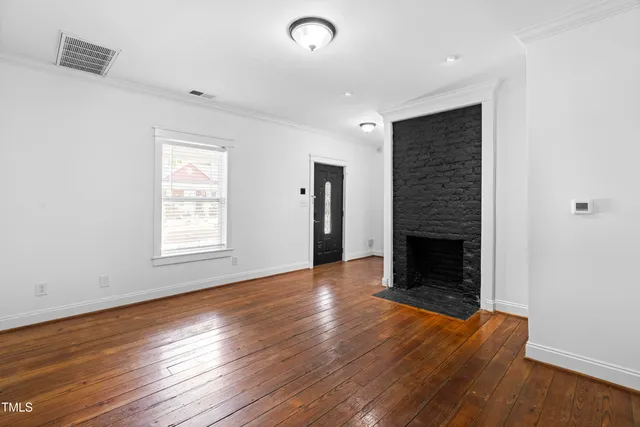 a bathroom with a shower a toilet and a window