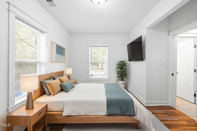 a bedroom with a bed and a flat screen tv