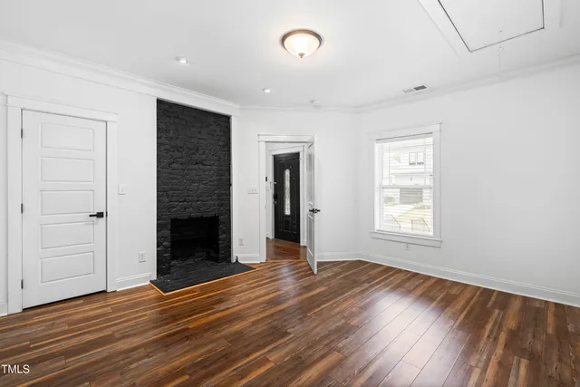 wooden floor in an empty room with a fireplace