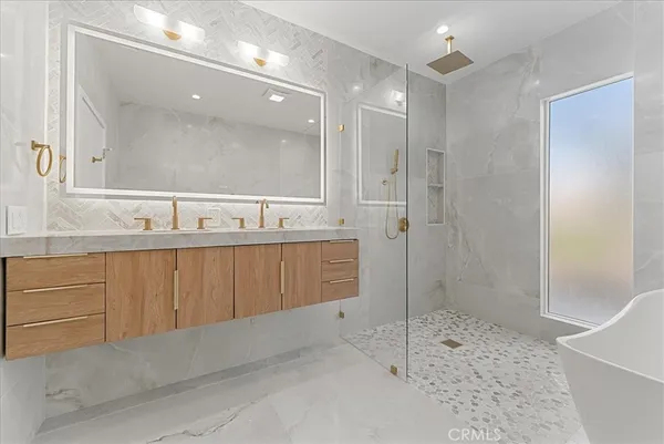 a bathroom with a sink a mirror and a shower
