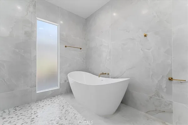 a bathroom with a double vanity sink toilet and shower