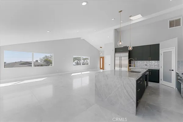 a view of a kitchen with a sink and a refrigerator