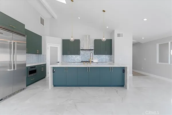 a large bathroom with a large mirror sink and stainless steel appliances