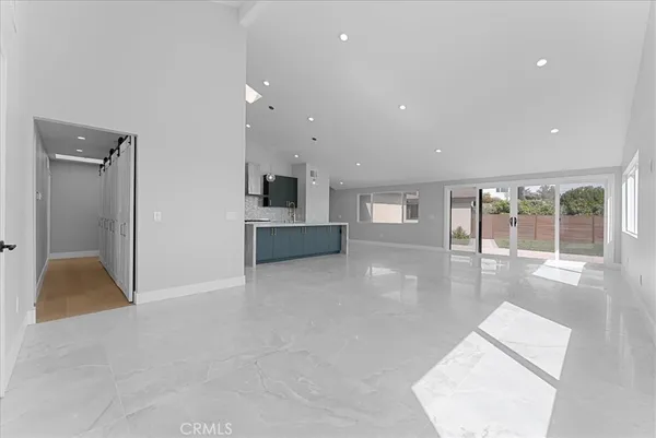 an empty room with wooden floor and a fireplace