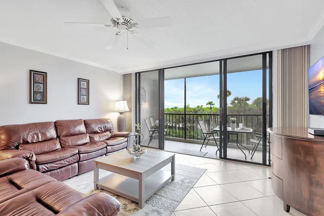 a living room with furniture and a floor to ceiling window