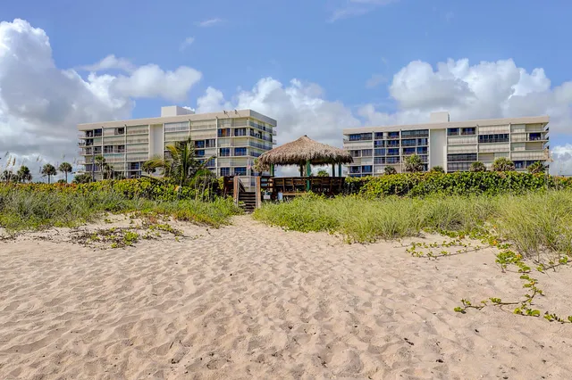 a view of a lake with a big yard and large trees