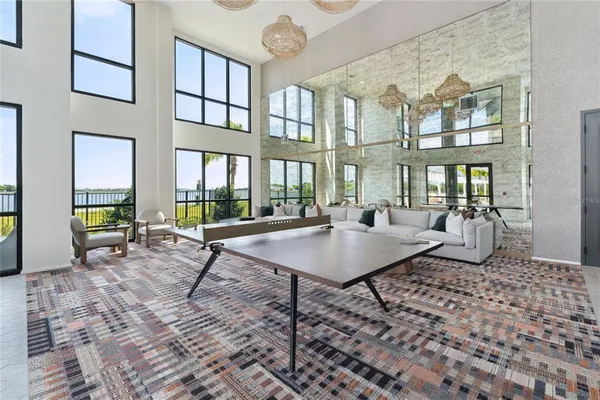a living room with furniture a rug and a large window