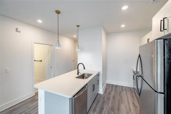 a kitchen with refrigerator cabinets and wooden floor
