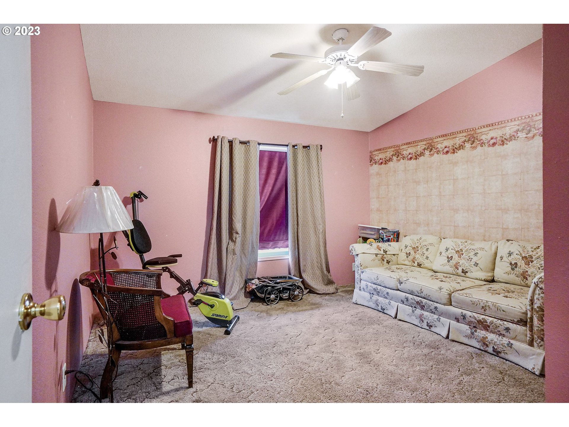 1015 Oak Street, Unit 100 Silverton, OR 97381 - Photo 11 of 30 a living room with a couch and a chandelier