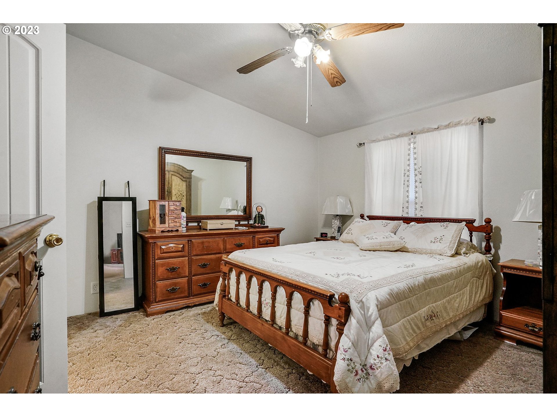 1015 Oak Street, Unit 100 Silverton, OR 97381 - Photo 15 of 30 a bedroom with a bed and a chandelier