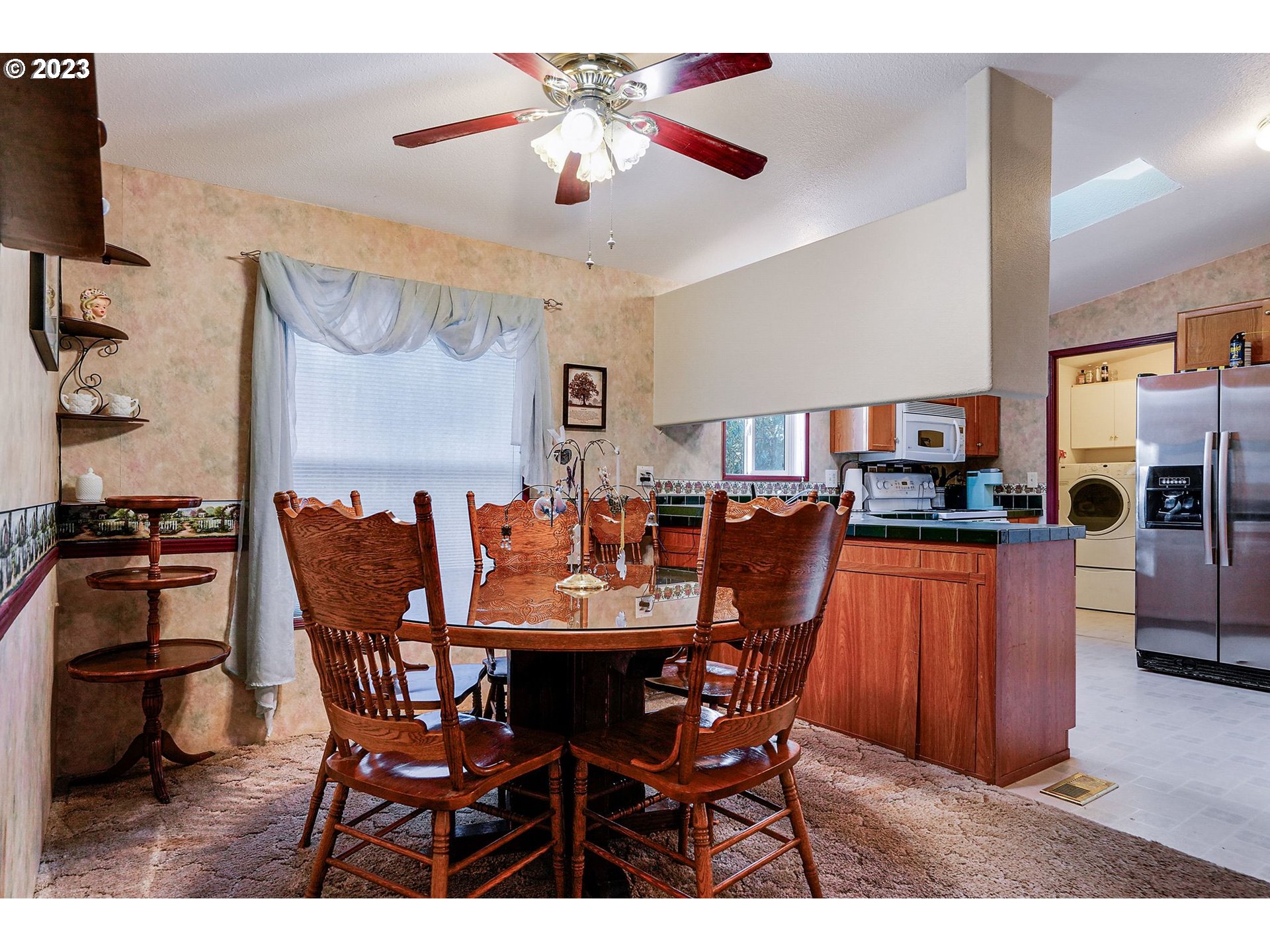 1015 Oak Street, Unit 100 Silverton, OR 97381 - Photo 5 of 30 a view of a dining room with furniture and a chandelier