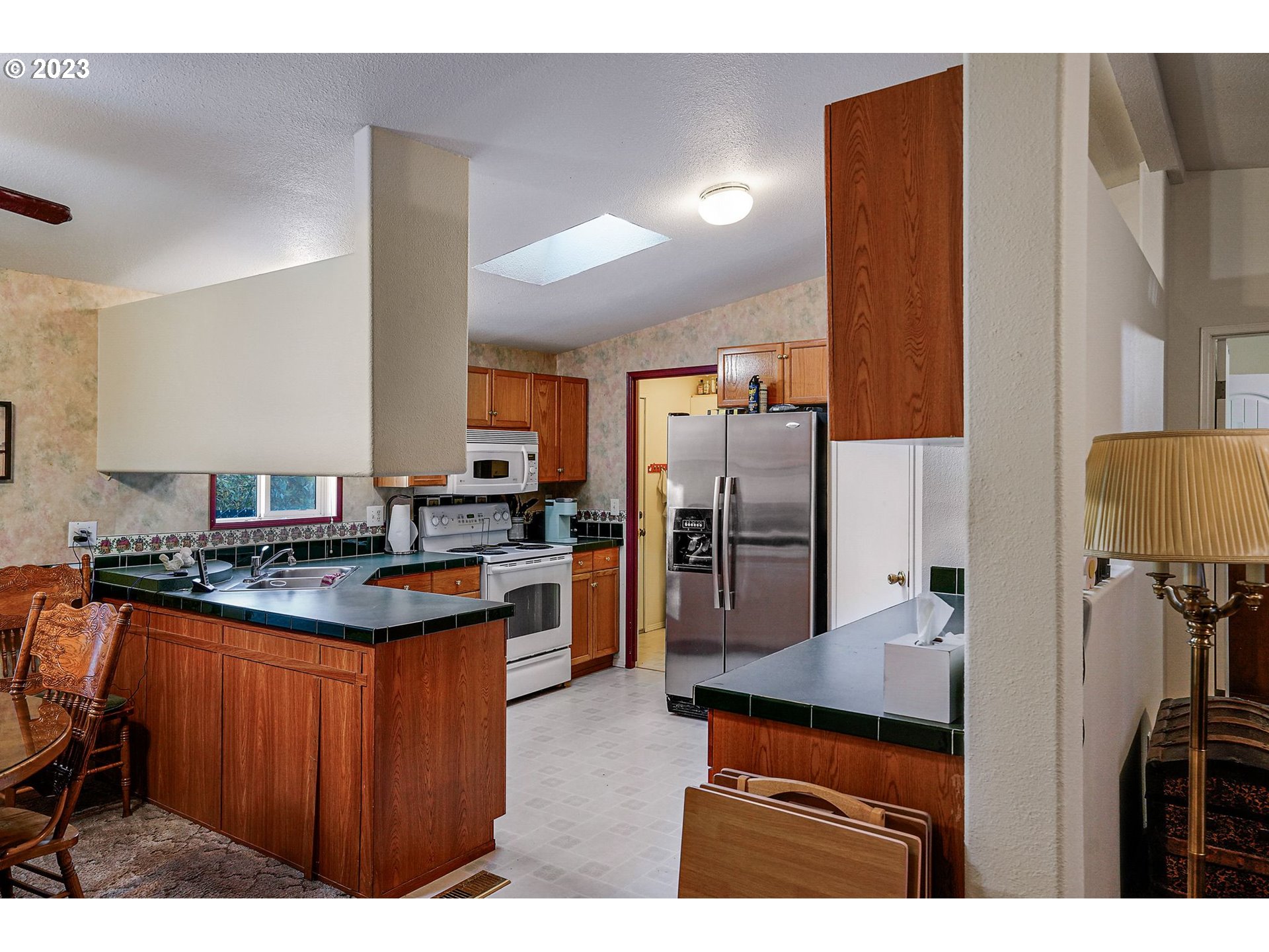 1015 Oak Street, Unit 100 Silverton, OR 97381 - Photo 6 of 30 a kitchen with stainless steel appliances granite countertop a stove a refrigerator and a refrigerator