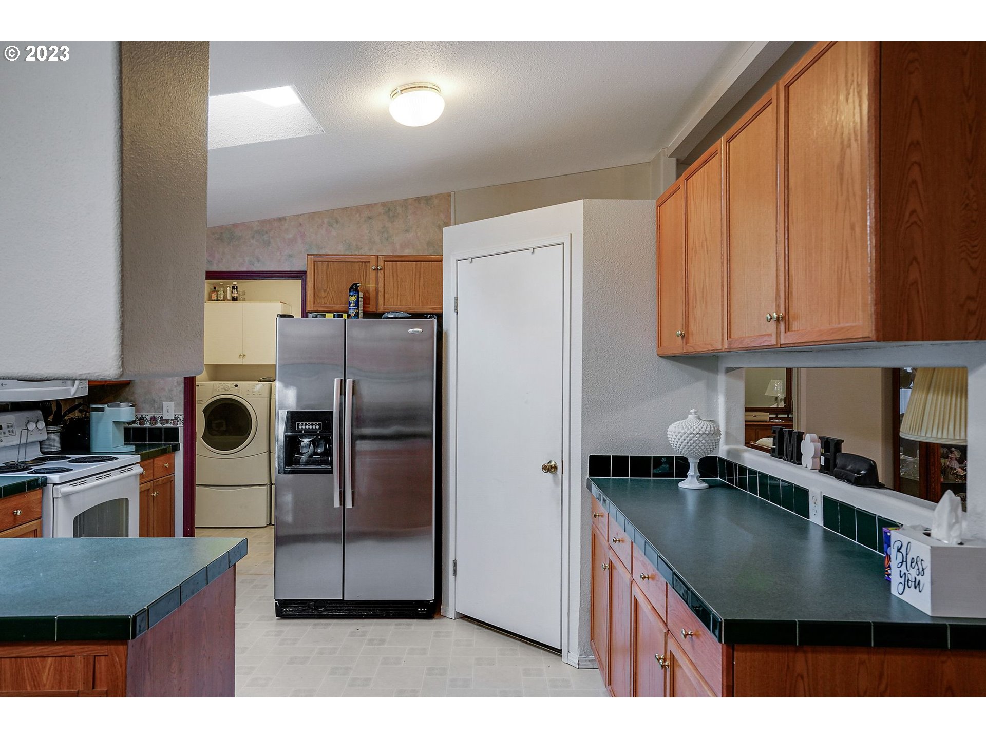 1015 Oak Street, Unit 100 Silverton, OR 97381 - Photo 7 of 30 a kitchen with stainless steel appliances granite countertop a refrigerator a stove a sink and a microwave