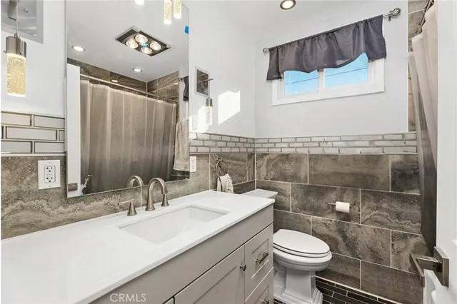 a bathroom with a sink toilet and mirror