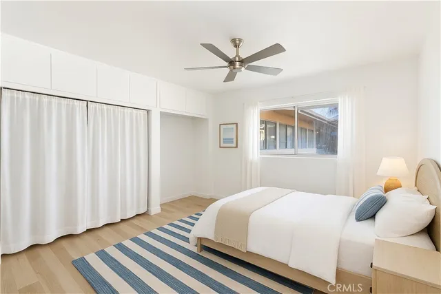 a bedroom with bed and wooden floor