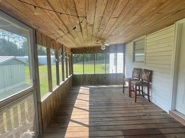 a view of a patio with a dining table and chairs