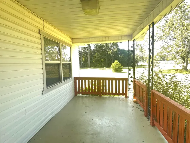 a view of a room with wooden floor and iron stairs