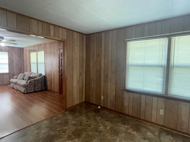 a view of a bedroom with a bed and a window