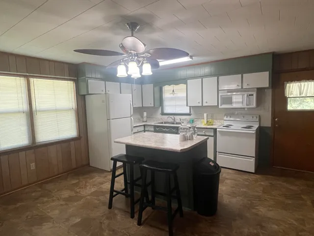 a kitchen with a stove a sink and cabinets