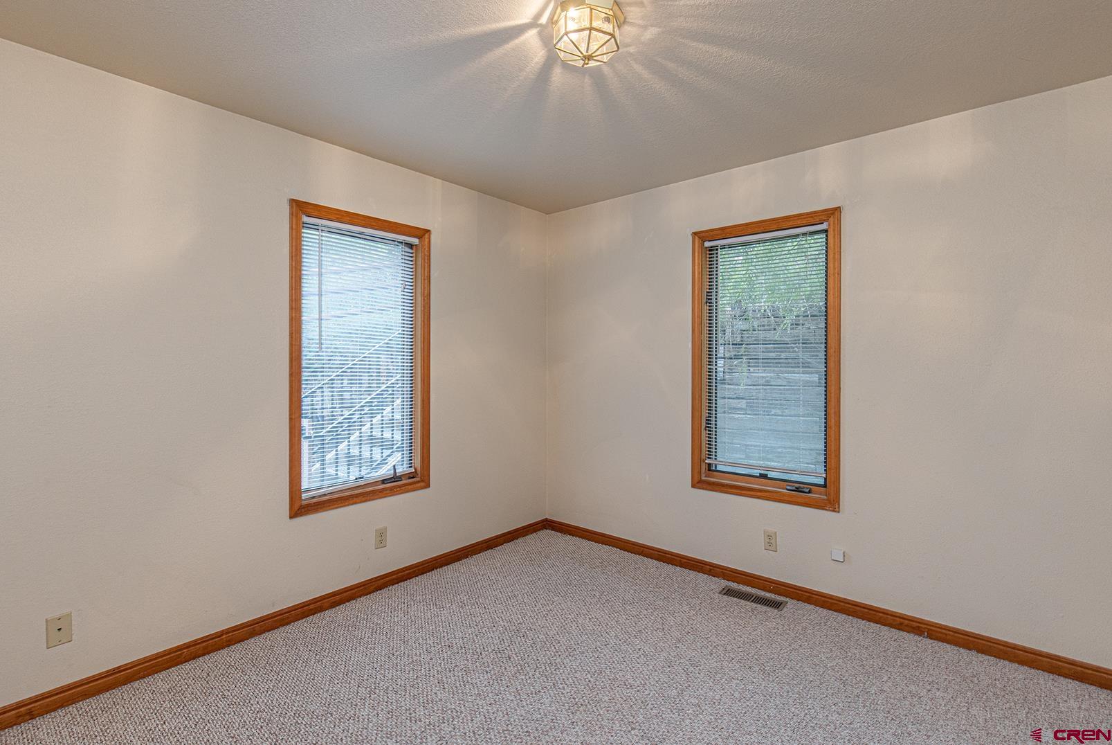 499 High Trails Drive Durango, CO 81301 - Photo 11 of 31 an empty room with windows and closet