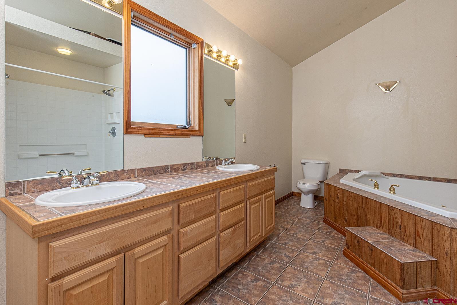 499 High Trails Drive Durango, CO 81301 - Photo 13 of 31 a spacious bathroom with a double vanity sink and a mirror