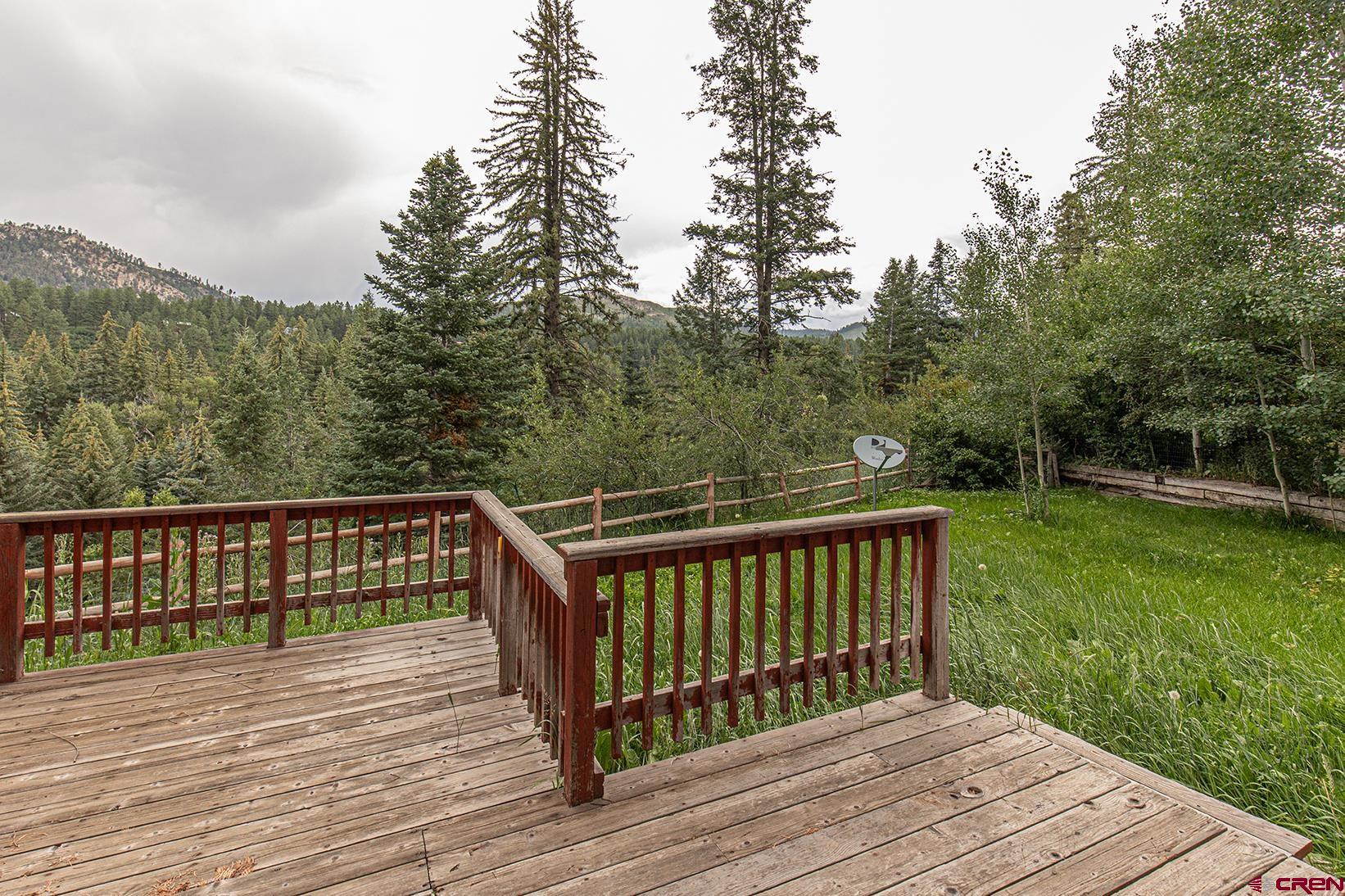 499 High Trails Drive Durango, CO 81301 - Photo 31 of 31 a balcony with wooden floor and yard in the back