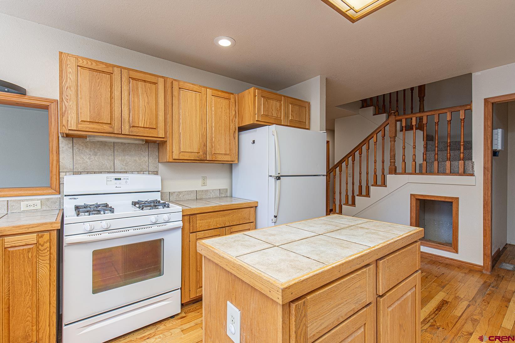 499 High Trails Drive Durango, CO 81301 - Photo 5 of 31 a kitchen with a stove a refrigerator and a stove