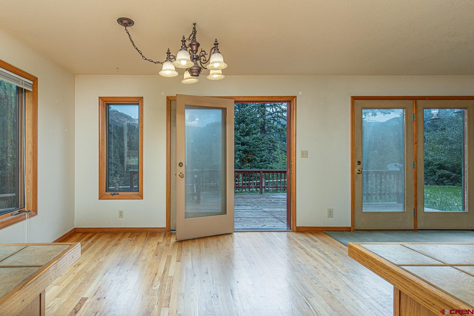 499 High Trails Drive Durango, CO 81301 - Photo 7 of 31 a view of an empty room with window and wooden floor