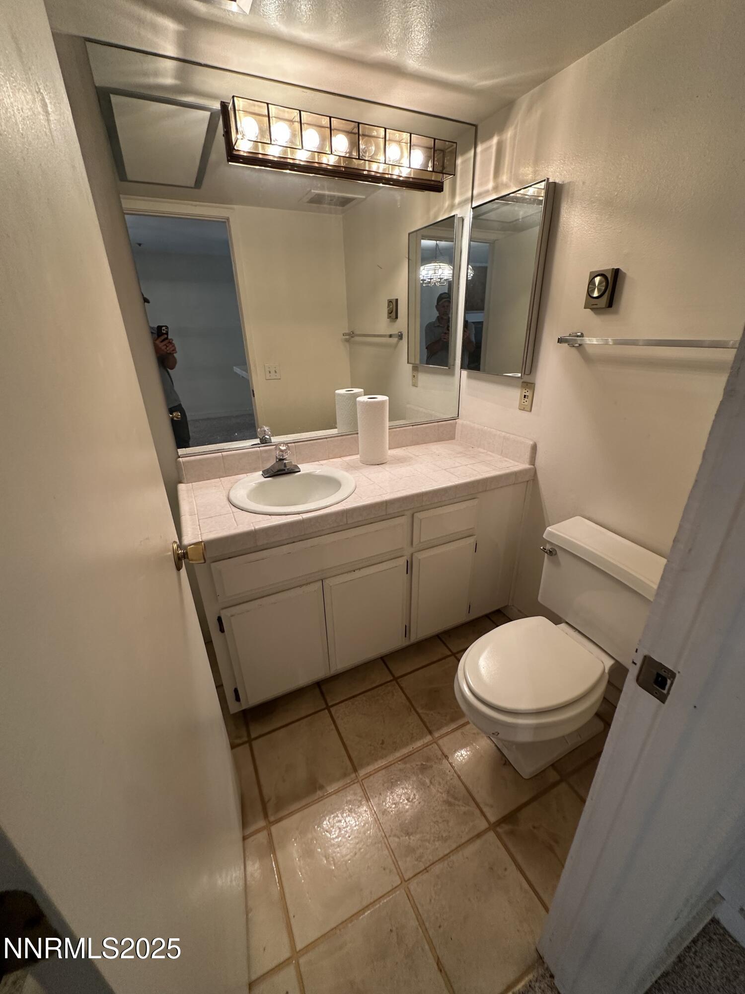 333 Ski Way, Unit 253 Incline Village, NV 89451 - Photo 7 of 13 a bathroom with a toilet sink and mirror