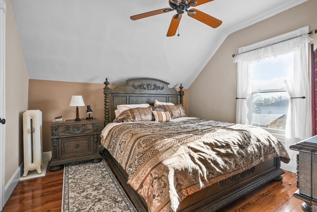 42 Pleasant Street, Unit C North Attleboro, MA 02760 - Photo 14 of 16 a bedroom with a bed and a chandelier