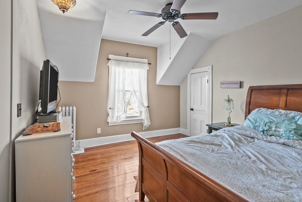 42 Pleasant Street, Unit C North Attleboro, MA 02760 - Photo 15 of 16 a bedroom with a bed and a flat tv screen on dresser
