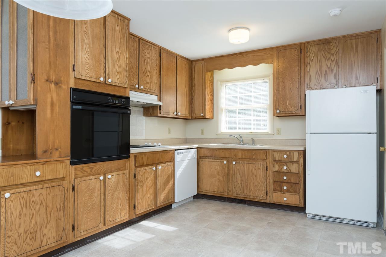 500 Pinecroft Drive Raleigh, NC 27609 - Photo 9 of 21 a kitchen with granite countertop white cabinets and refrigerator