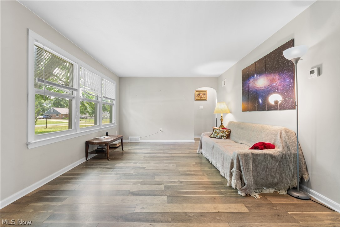5768 Nolley Road Akron, OH 44319 - Photo 14 of 38 Living area featuring wood-finish flooring, light neutral wall tones, and white baseboards