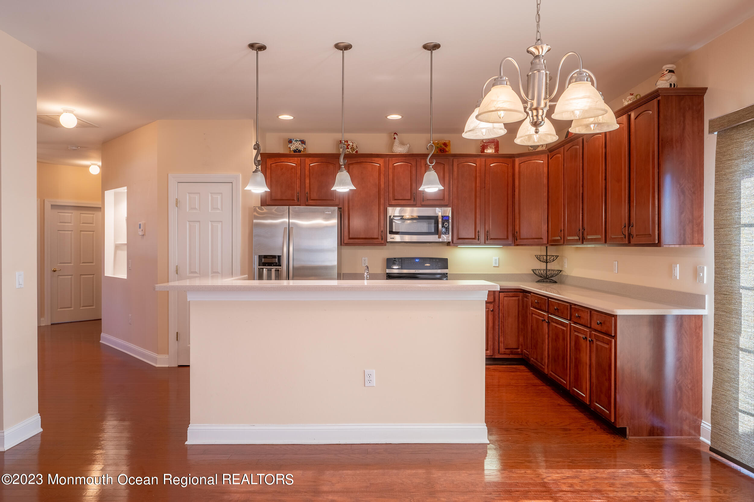 2 Springdale Road Manchester Township, NJ 08759 - Photo 10 of 37 a kitchen with stainless steel appliances granite countertop a sink a stove and a wooden floors