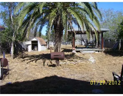 a backyard of a house with table and chairs