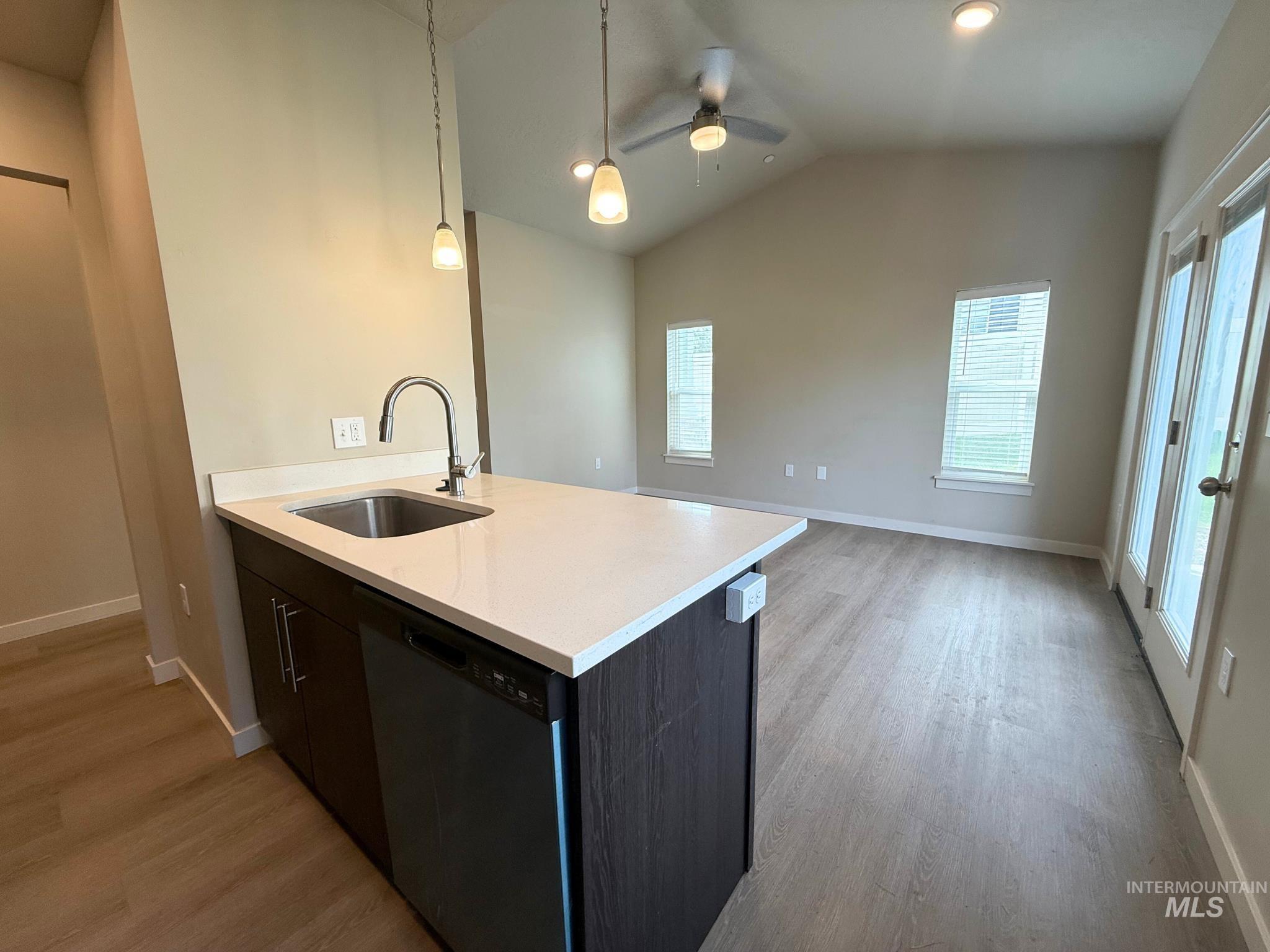 616 North 44th Street Nampa, ID 83687 - Photo 15 of 18 Kitchen with dishwasher, light wood-style flooring, pendant lighting, vaulted ceiling, and open floor plan
