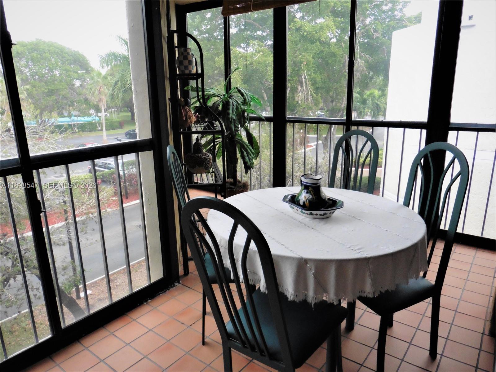 16200 Golf Club Road, Unit 312 Weston, FL 33326 - Photo 18 of 31 a view of a dining room with furniture window and outside view