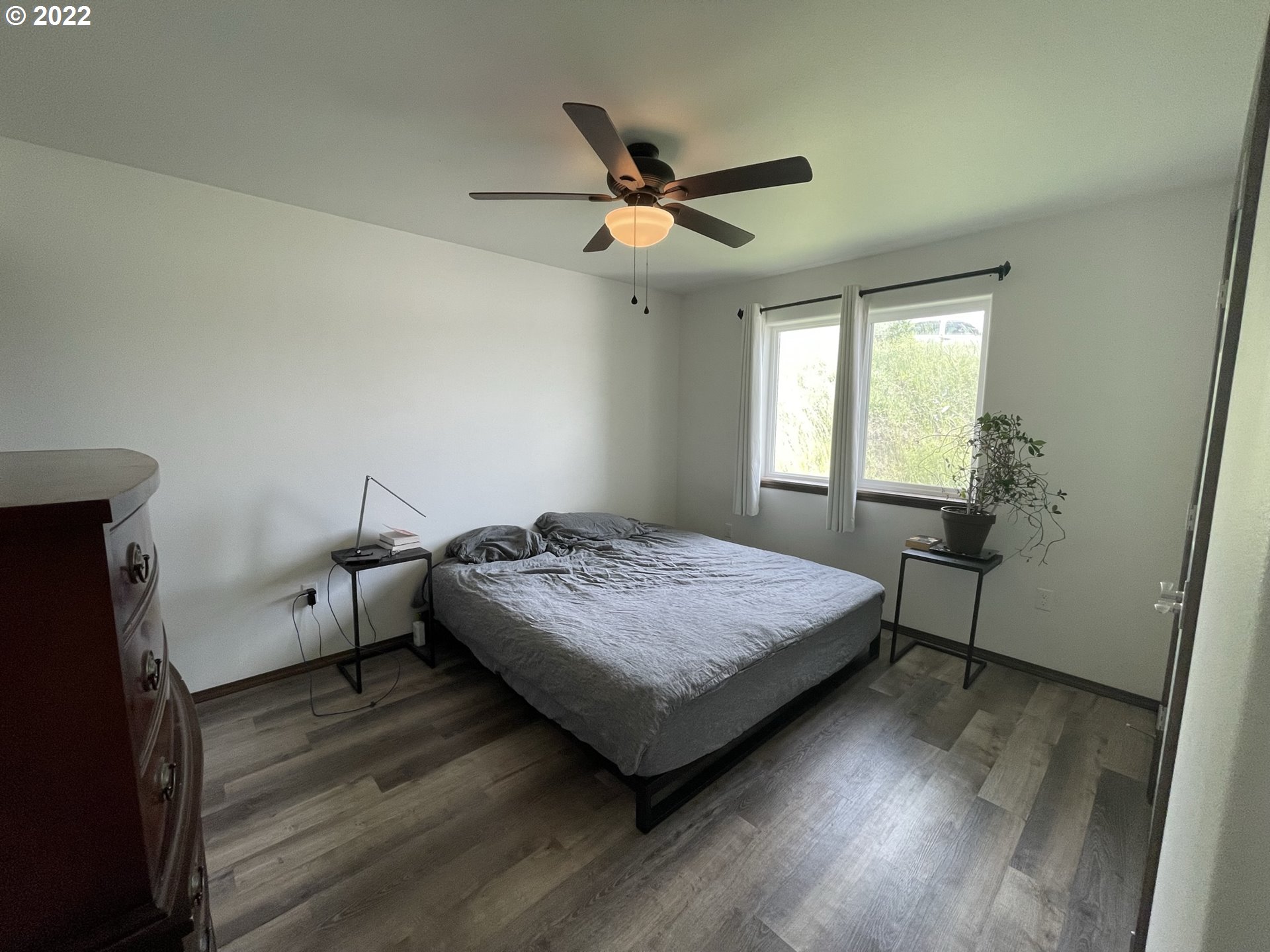 1235 Southwest 12th Street Pendleton, OR 97801 - Photo 13 of 17 a bedroom with a bed and a chandelier