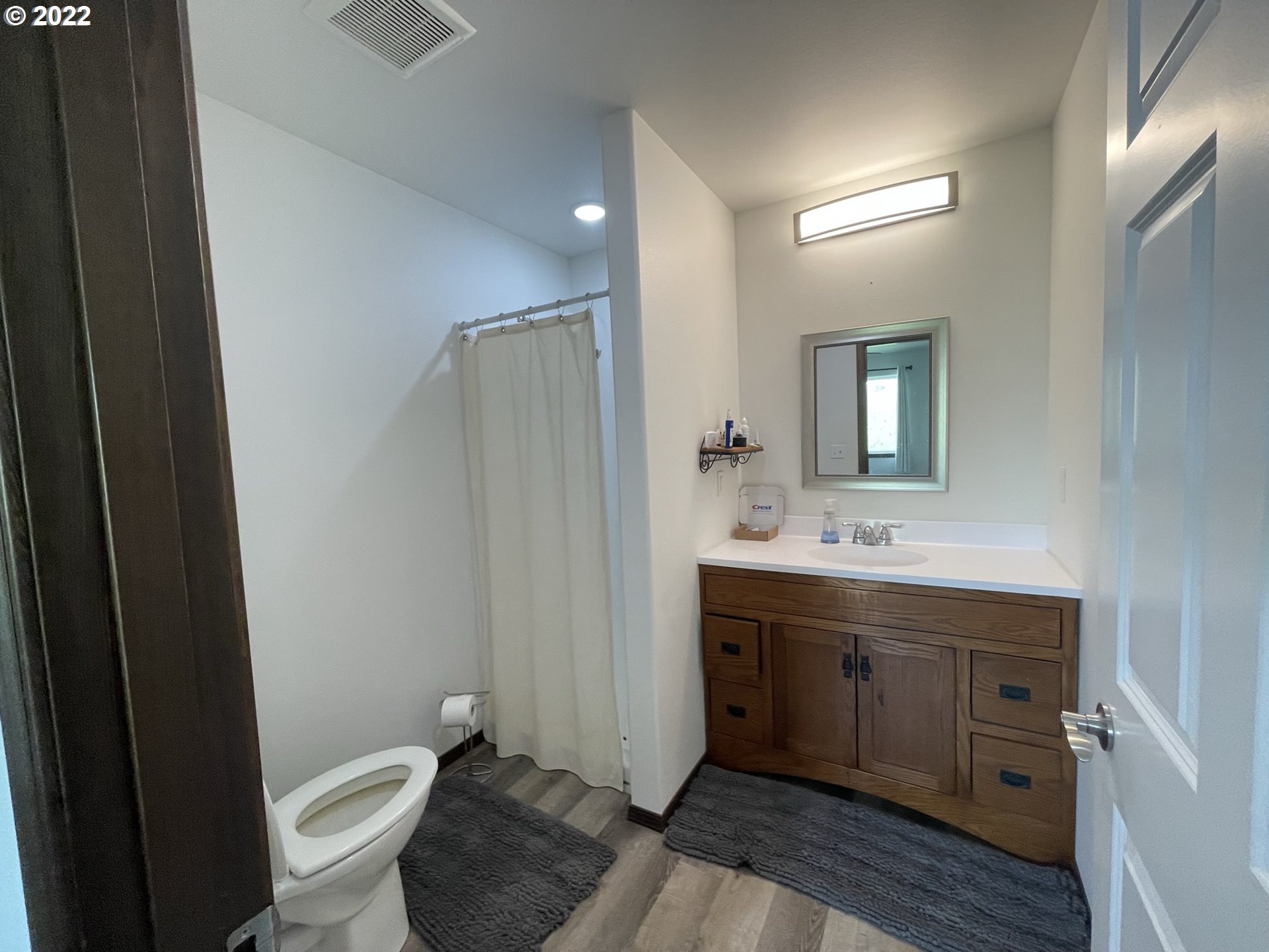 1235 Southwest 12th Street Pendleton, OR 97801 - Photo 14 of 17 a bathroom with a toilet a sink and mirror