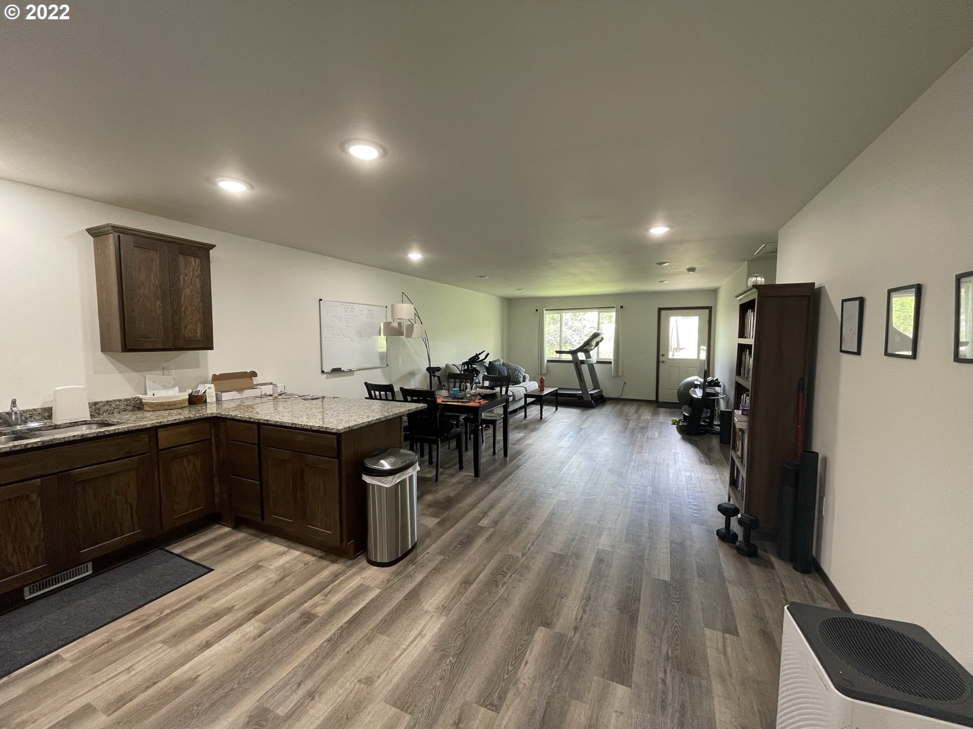 1235 Southwest 12th Street Pendleton, OR 97801 - Photo 3 of 17 a kitchen with stainless steel appliances granite countertop a refrigerator a sink dishwasher a oven and a dining table with wooden floor