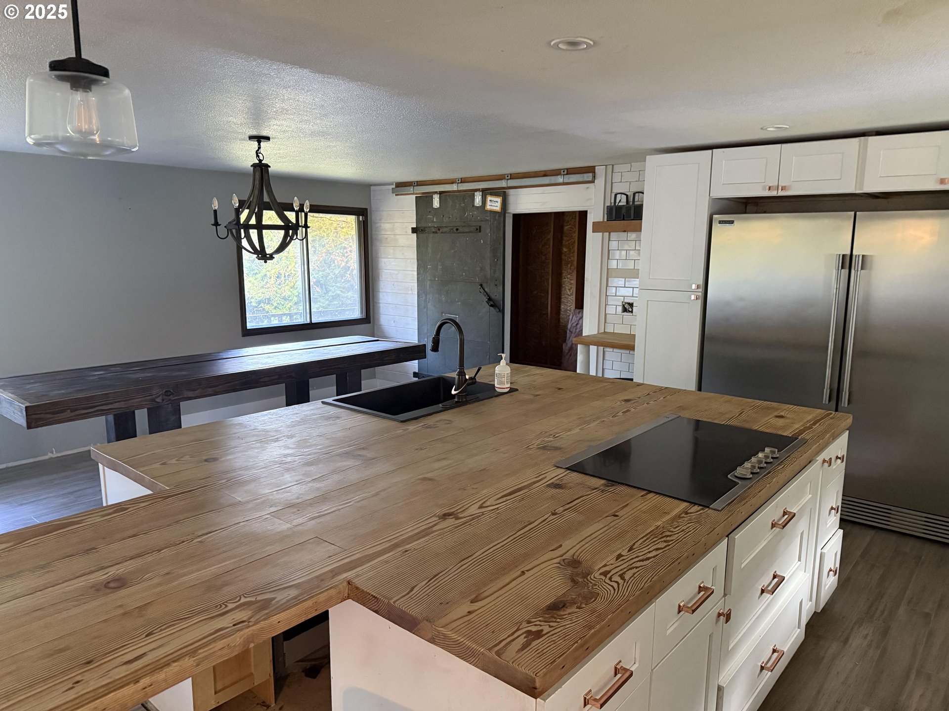33320 Southeast Francis Street Gresham, OR 97080 - Photo 4 of 40 a kitchen with kitchen island a counter top a refrigerator and a sink