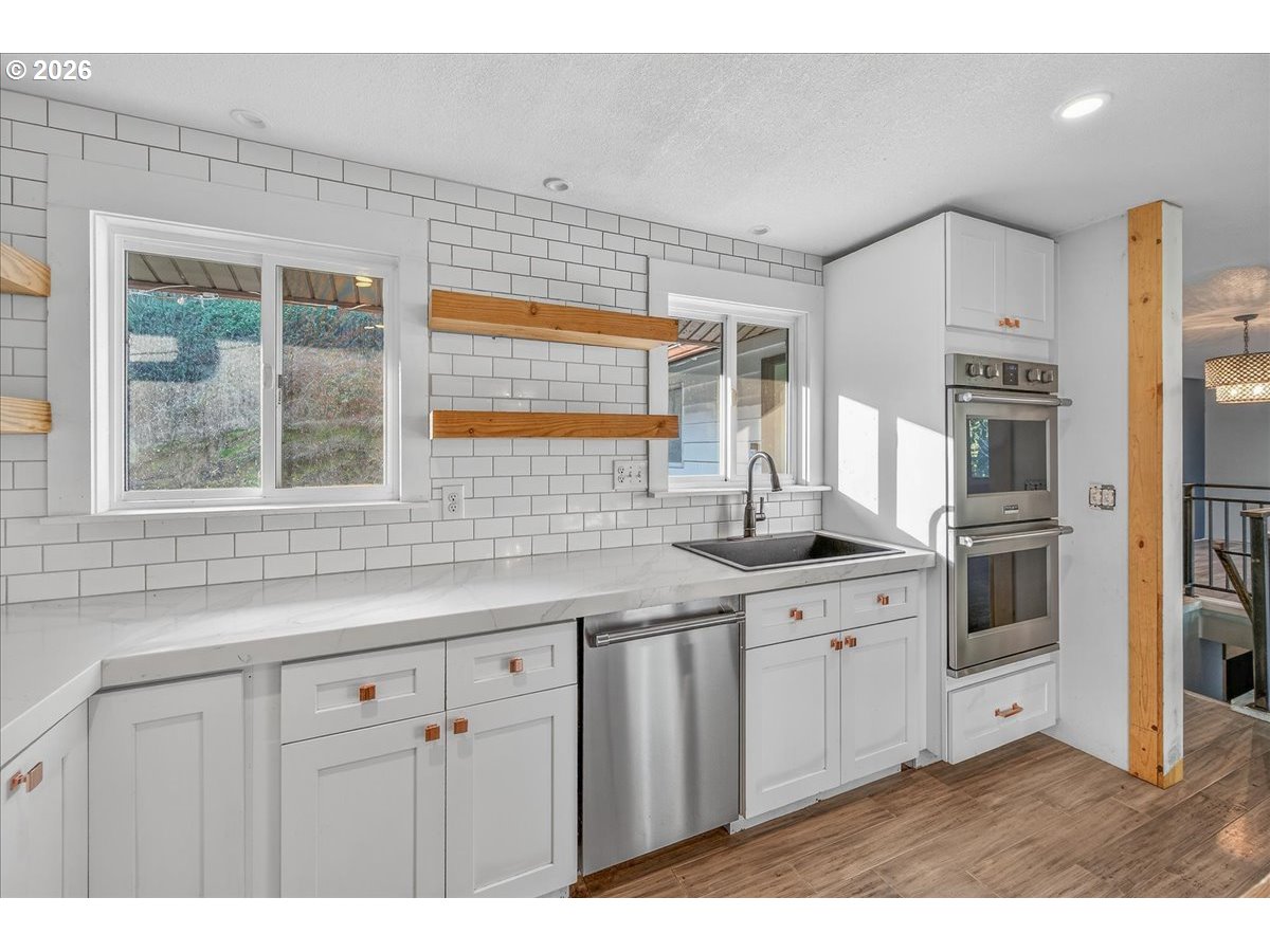 33320 Southeast Francis Street Gresham, OR 97080 - Photo 10 of 40 a kitchen with granite countertop a sink stainless steel appliances and cabinets