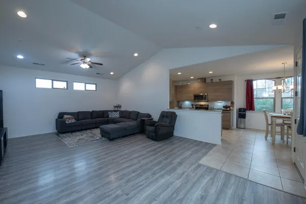 a living room with furniture and kitchen view
